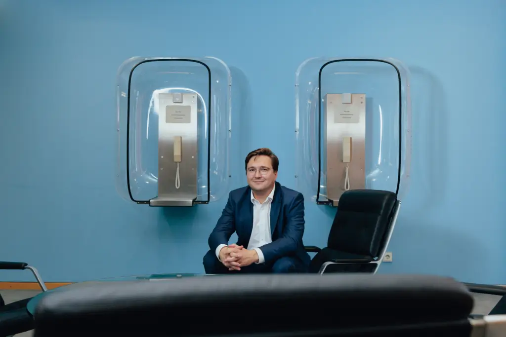 Christian Moser (MdB, CSU) vor blauer Wand an Telefonzellenaufgängung im Matthias-Erzberger-Haus (Unter den Linden 71)